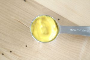 close up of 1 tablespoon of yellow mustard