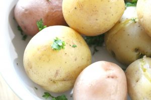 close up of cooked potatoes with parsley on top