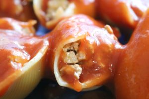taco stuffed shells - close up of shells, meat filling and taco sauce