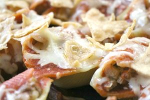 taco stuffed shells with melted cheese and toasty tortilla chips