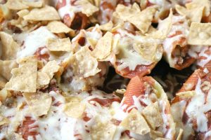 taco stuffed shells with melted cheese and toasty tortilla chips