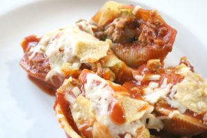 taco stuffed shells with melted cheese and toasty tortilla chips