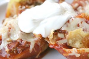 taco stuffed shells with melted cheese and toasty tortilla chips